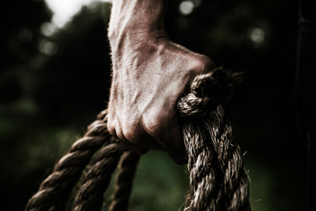 Man holding brown rope