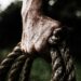 Man holding brown rope